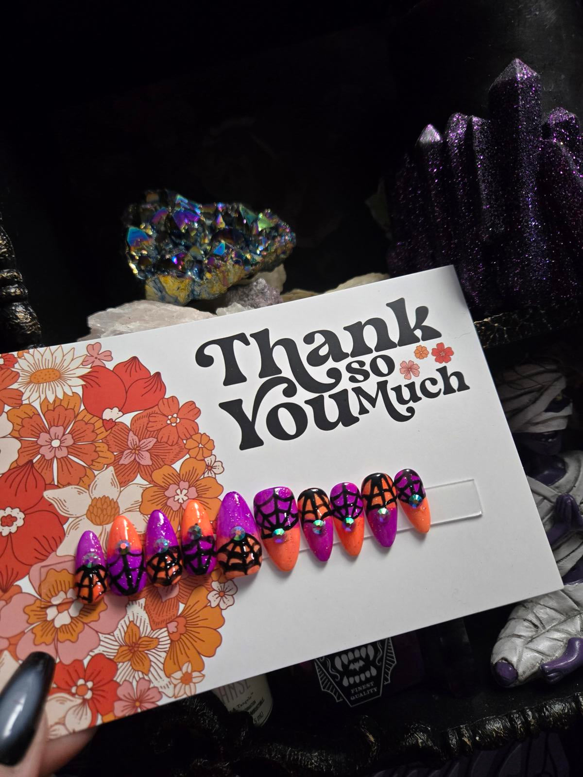 split color spiderweb halloween nails with gems