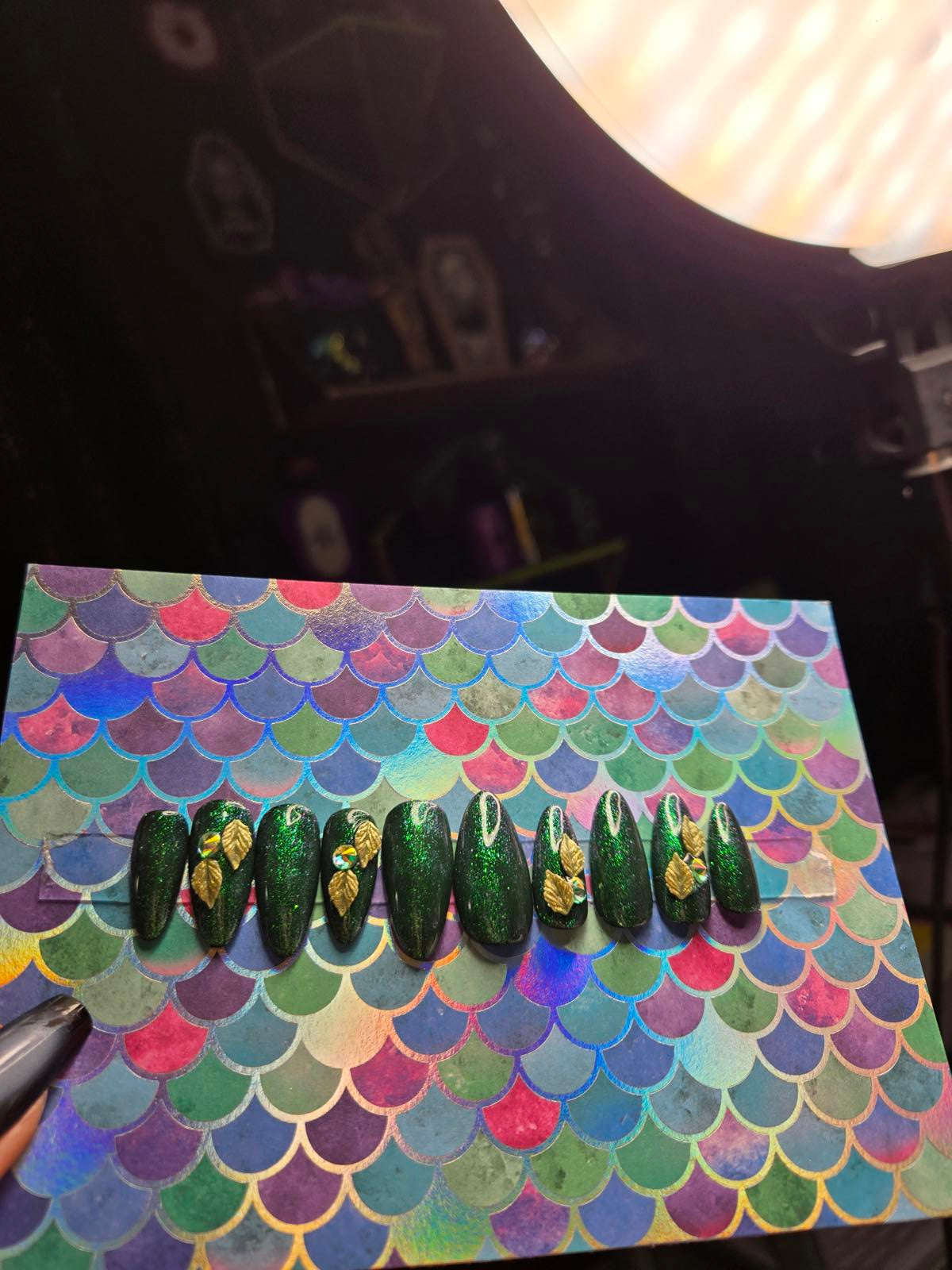 Green almond shaped press on nails with leaf charms