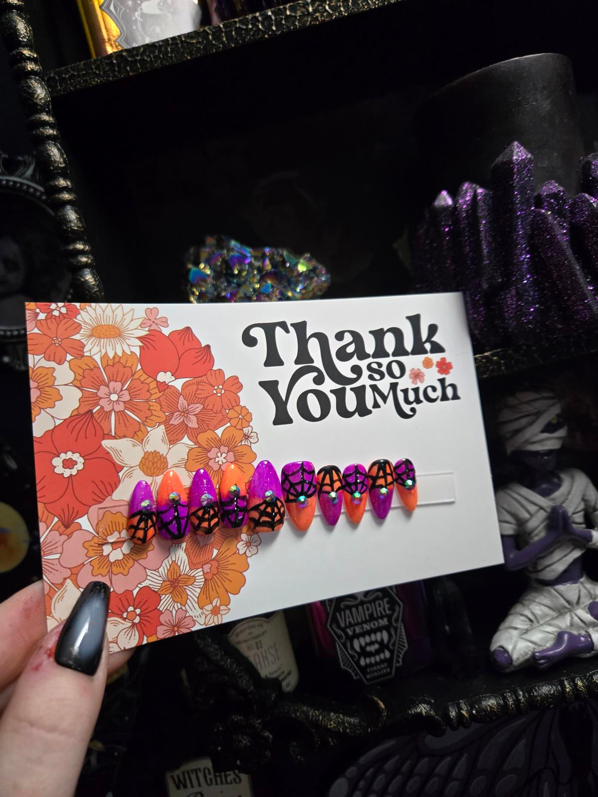 split color spiderweb halloween nails with gems
