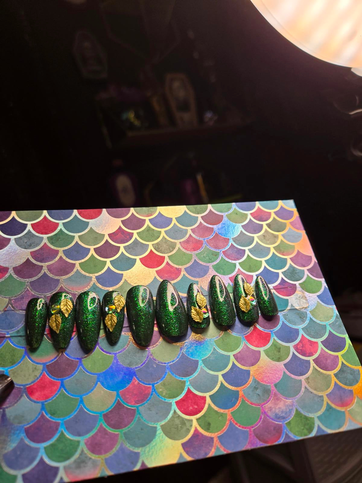 Green almond shaped press on nails with leaf charms