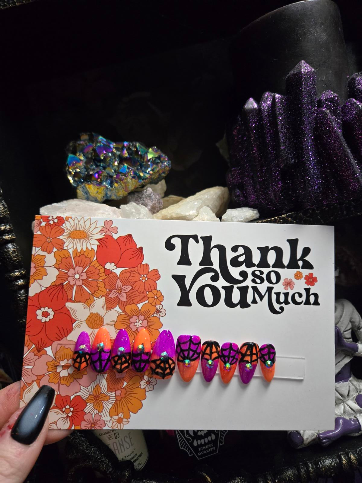 split color spiderweb halloween nails with gems
