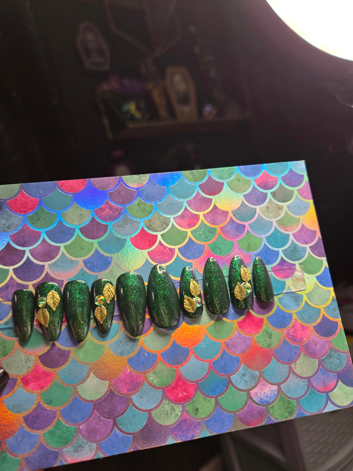 Green almond shaped press on nails with leaf charms