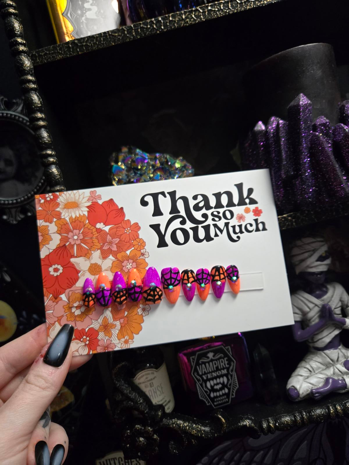 split color spiderweb halloween nails with gems