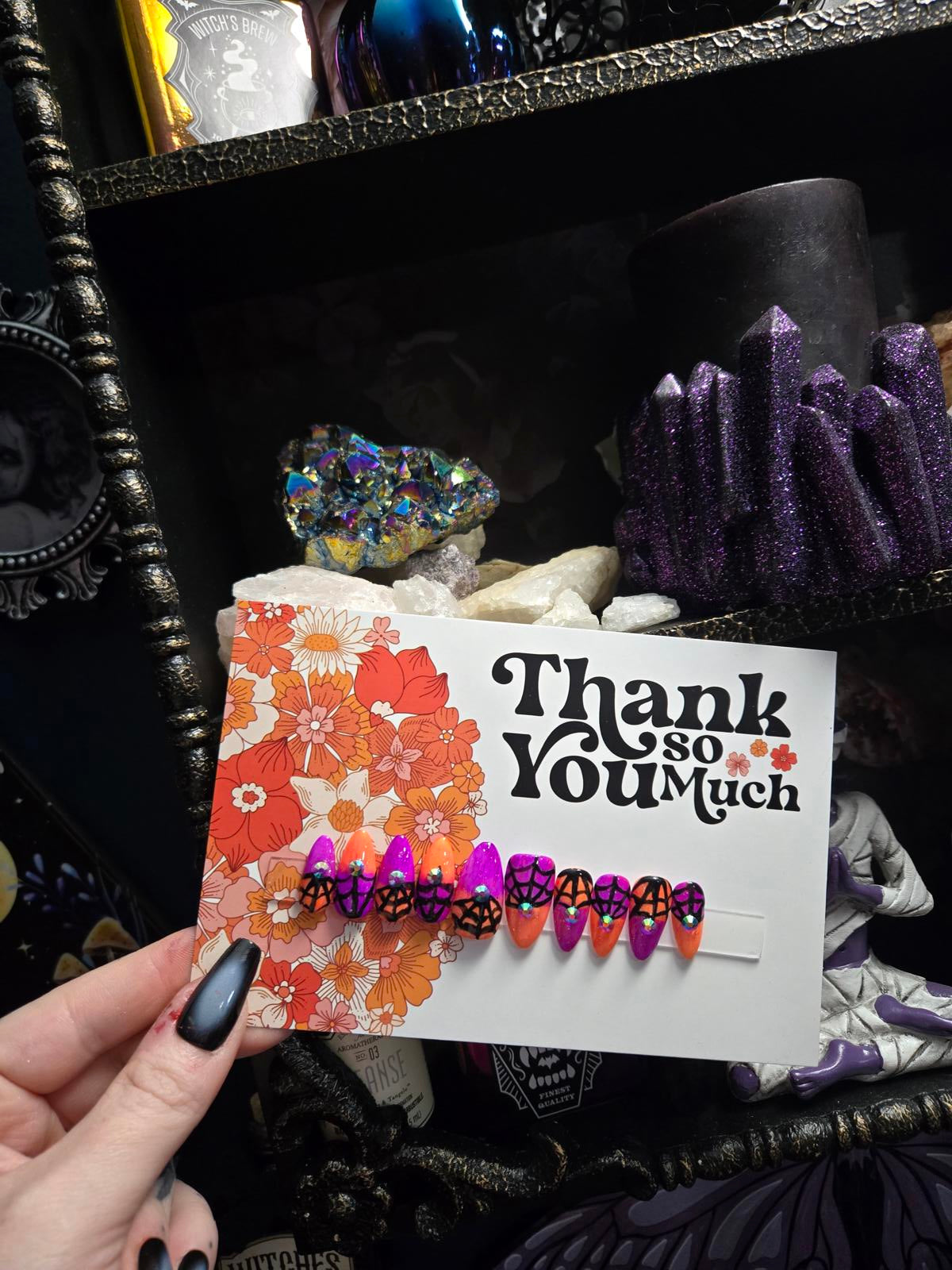 split color spiderweb halloween nails with gems