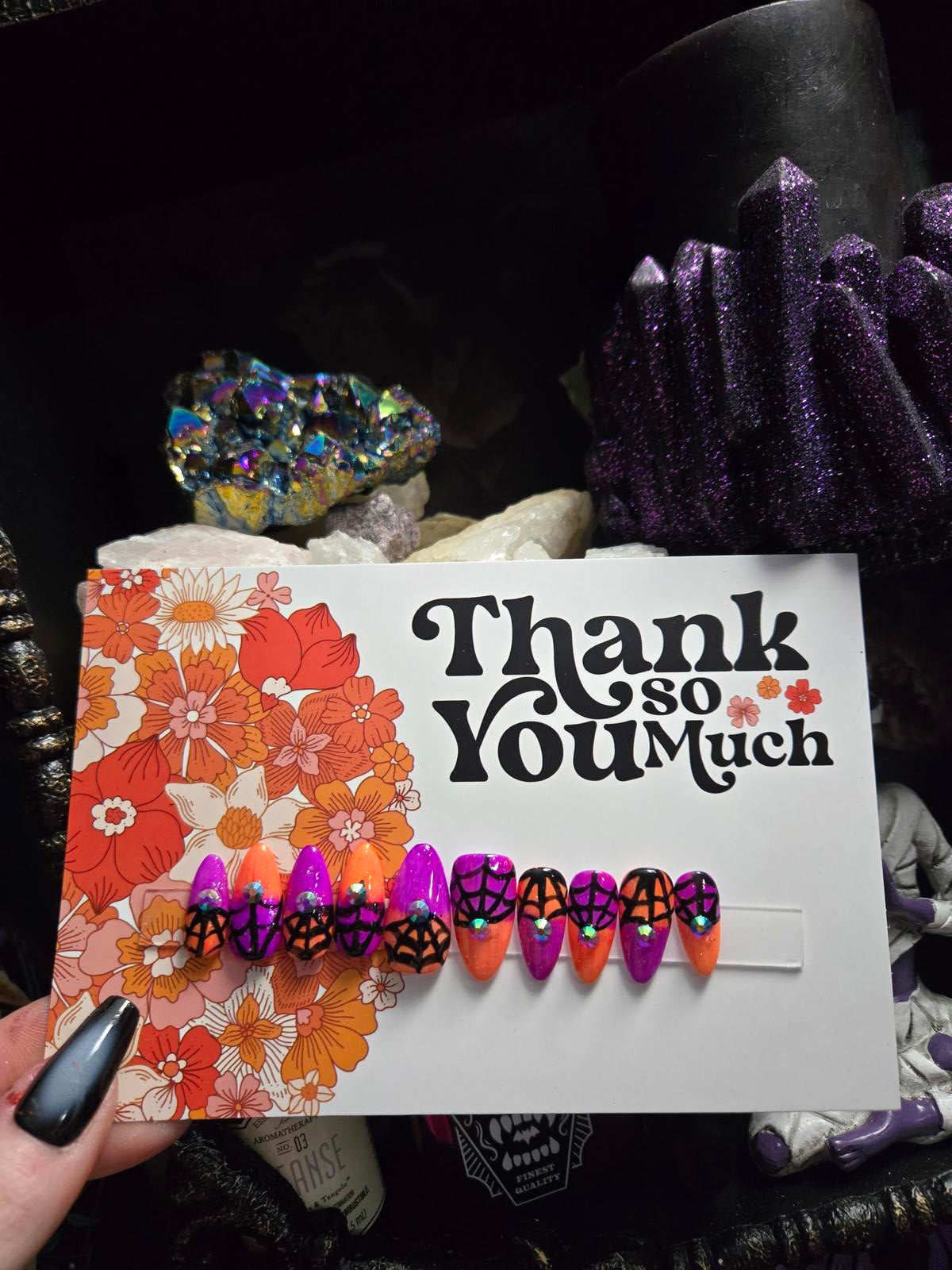 split color spiderweb halloween nails with gems