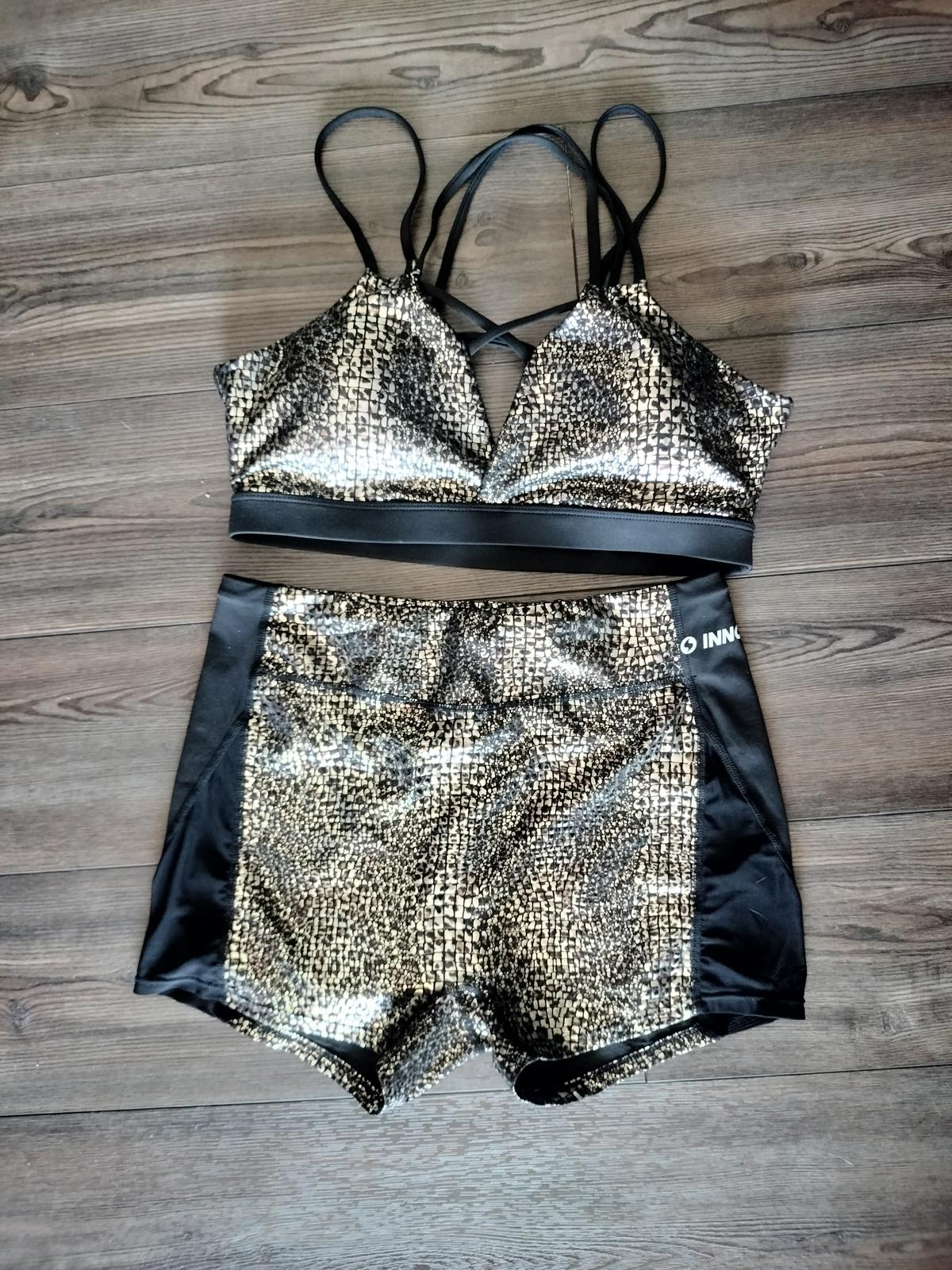 Black and gold activewear shorts and sports bra set