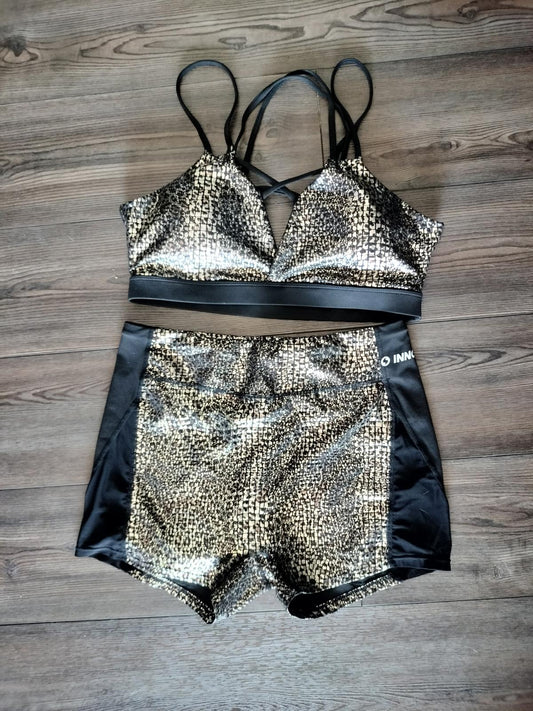 Black and gold activewear shorts and sports bra set