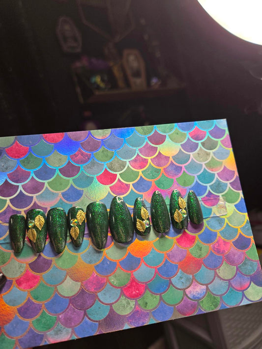 Green almond shaped press on nails with leaf charms
