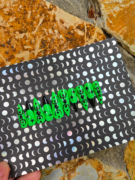 Green and black witchy stiletto nails custom made