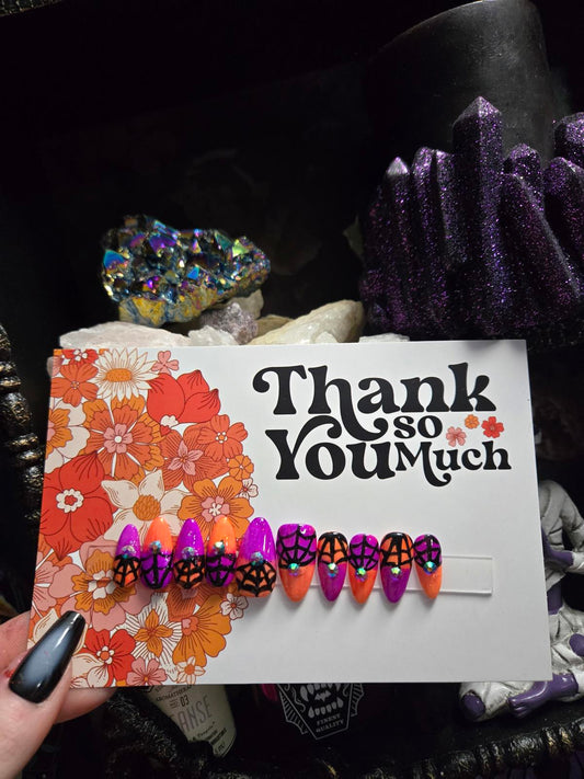 split color spiderweb halloween nails with gems