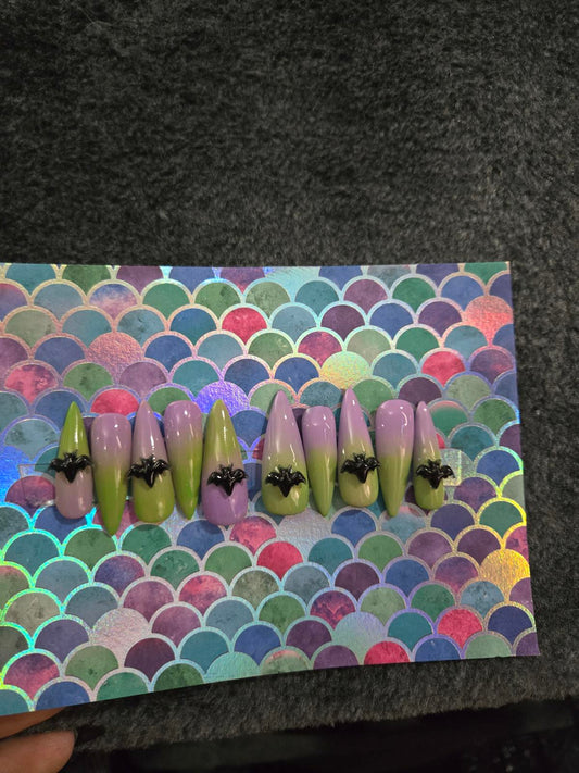 Long stiletto press on nails green to lavender ombre with bat charms
