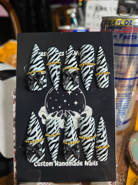 Zebra bow and chain stiletto nails